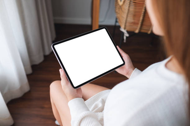 istock a woman holding digital tablet with blank desktop screen at home 1339187972