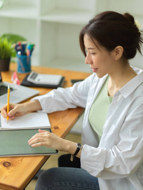 istock Asian young business startup working on digital tablet 1339189016