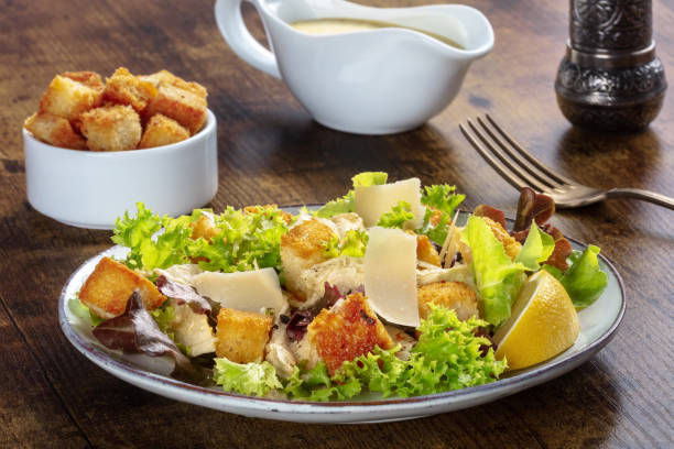 istock Chicken Caesar salad with the classic mayonnaise based sauce and croutons 1339189626