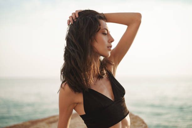 istock Young smiling woman outdoors portrait at beach 1339197417