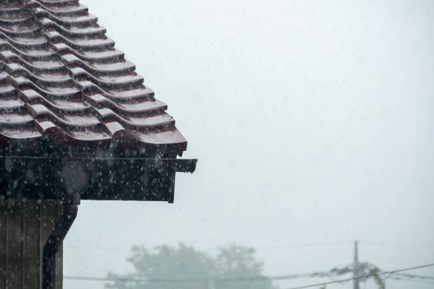 istock Heavy rain hitting a tiled roof 1339197572
