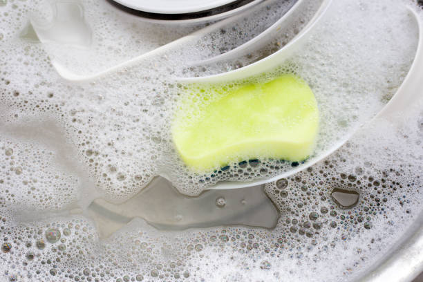 istock Washing dishes, Close up of utensils soaking in kitchen sink. 1339199657