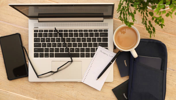istock Passports, laptop, phone and notepad. Booking holiday or vacation 1339200967