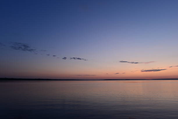 istock Blue clear sky in the summer twilight on the lake 1339201163