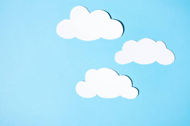 istock Clouds of white paper on a blue background. Flat lay, place for text. 1339203199
