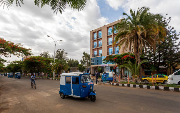 tigray woman walking in center of of Aksum, Ethiopia Africa Axum, Ethiopia, April 27th.2019: Tuk Tuk, traditional vehicle on the street of Aksum on April 27, 2019 in Aksum, Tigray, Ethiopia Africa ethiopia city stock pictures, royalty-free photos & images