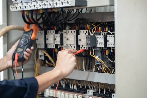 istock Electrician engineer work tester measuring voltage and current of power electric line in electrical cabinet control , concept check the operation of the electrical system . 1339205938