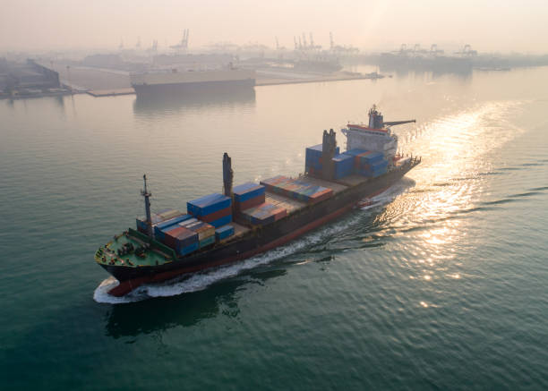 istock Container ship in export and import business and logistics. Shipping cargo to harbor by crane. Water transport International. Aerial view and top view. 1339206016