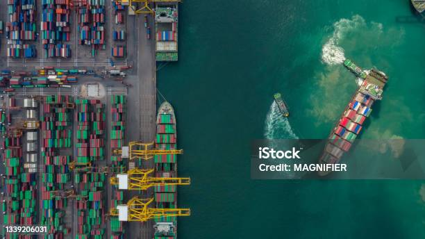 Container Ship In Export And Import Business And Logistics Shipping Cargo To Harbor By Crane Water Transport International Aerial View And Top View Stock Photo - Download Image Now