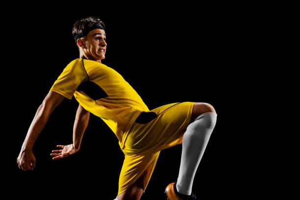 istock One profession young male football player training on black backround 1339206185