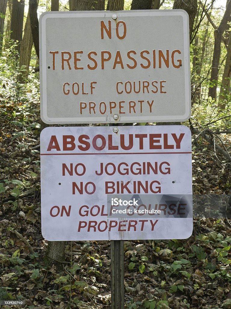 Stay out if you aren't golfing Signs in public woods to discourage trespassing on private golf course Accessibility Stock Photo