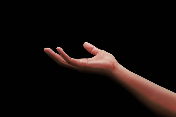 Holding man hand and finger gesture for help support care concept isolated on black background with showing assistance or trust design.