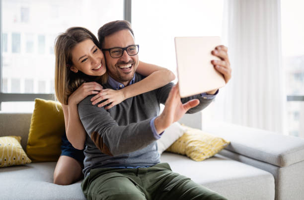 istock Happy couple in love having fun with digital tablet 1339208712