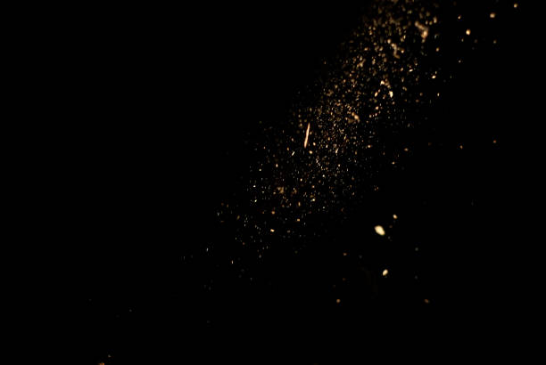 istock Dust and wood chips on a black background. Dirt particles fly in the air. Layout for design. Some dust particles are blurred to transmit the effect of motion. 1339208975