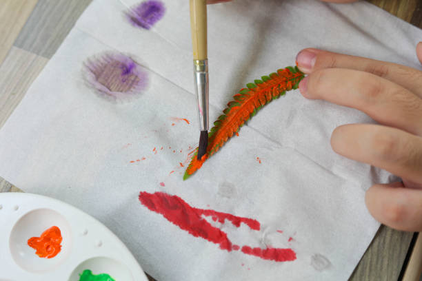 istock Asian cute girl doing leaf art 1339209674