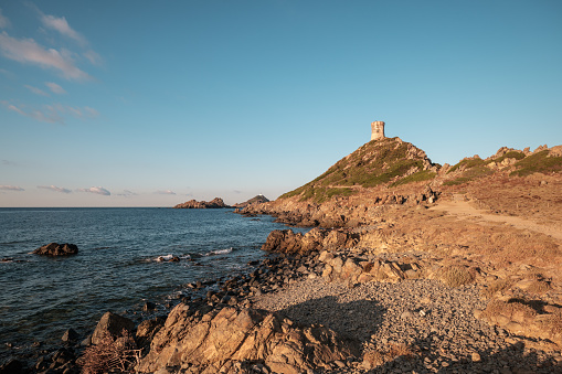 The Genoese tower and lighthouse at Pointe de la Parata and Les Iles Sanguinaires near Ajaccio in Corsica under a deep blue sky