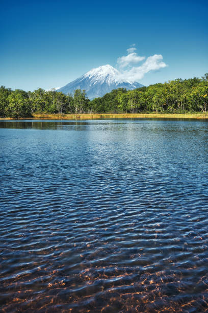 View of the Koryaksky volcano from the shore of the lake stock photo
