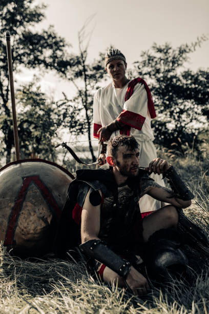 istock Ancient warrior and woman archer rest near shield and spear. 1339212061