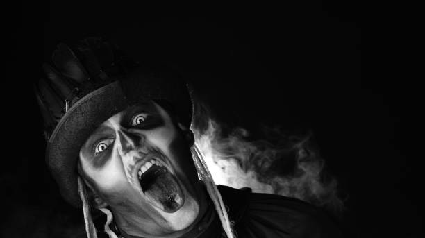 istock Creepy, crazy man with skeleton makeup. Guy making angry faces, shaking head, showing tongue 1339212101