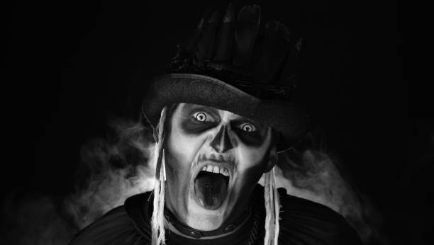istock Creepy, crazy man with skeleton makeup. Guy making angry faces, shaking head, showing tongue 1339212119
