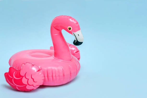 istock Inflatable pink flamingo for the pool on a blue background. 1339216991