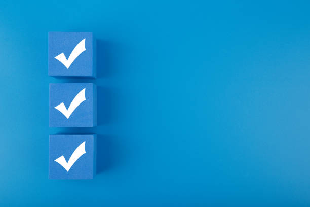 Three checkmarks on blue cubes against blue background with copy space Modern minimal flat lay with three white checkmarks on blue cubes against blue background with copy space. Concept of questionary, checklist, to do list or planning checklist stock pictures, royalty-free photos & images