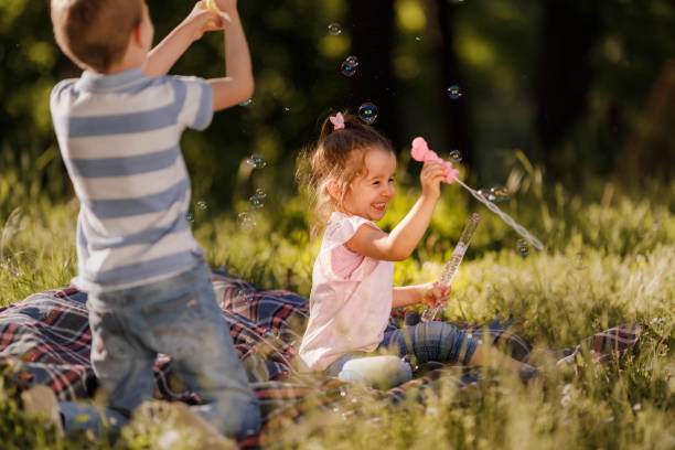 istock Playful little siblings having fun during spring day in nature. 1339223774