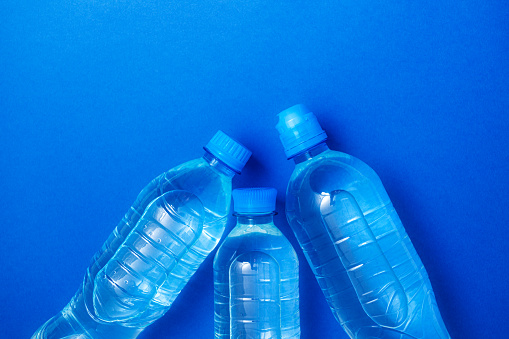 Bottles of still water on blue background