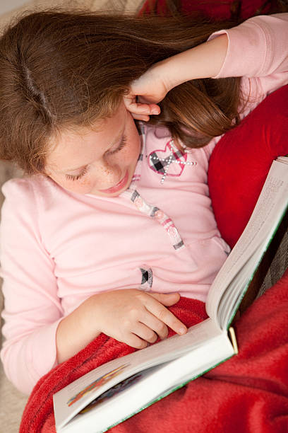 istock girl rest on sofa and reading the book 133922642