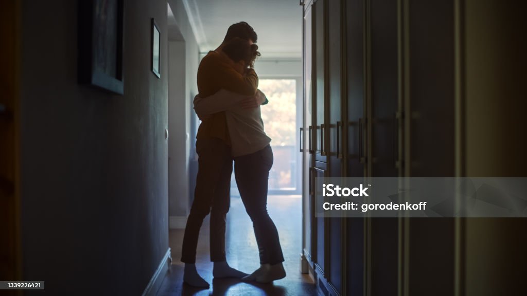 Sad Couple Embracing, Comforting Each other in Difficult Times. Family Overcoming Difficulties Together, Tender Moment. Atmosphere of Sadness and Tragedy. Moment of Human Drama Couple - Relationship Stock Photo