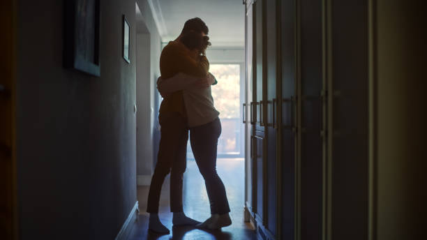 Sad Couple Embracing, Comforting Each other in Difficult Times. Family Overcoming Difficulties Together, Tender Moment. Atmosphere of Sadness and Tragedy. Moment of Human Drama Sad Couple Embracing, Comforting Each other in Difficult Times. Family Overcoming Difficulties Together, Tender Moment. Atmosphere of Sadness and Tragedy. Moment of Human Drama sadness stock pictures, royalty-free photos & images