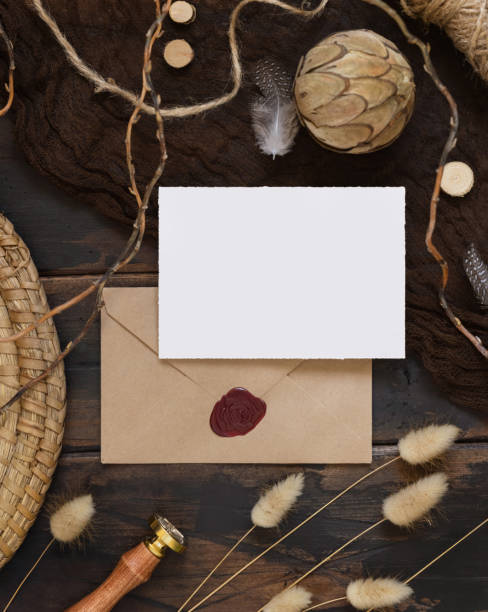 istock Blank paper card and envelope on a wooden table with dried plants 1339228187