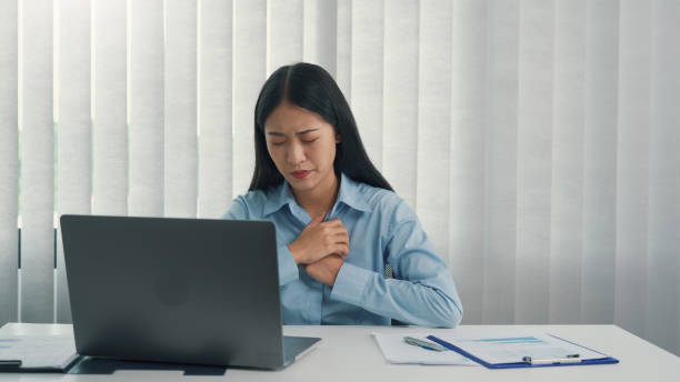 istock Asian woman felt pain in her chest while sitting at work. 1339228320