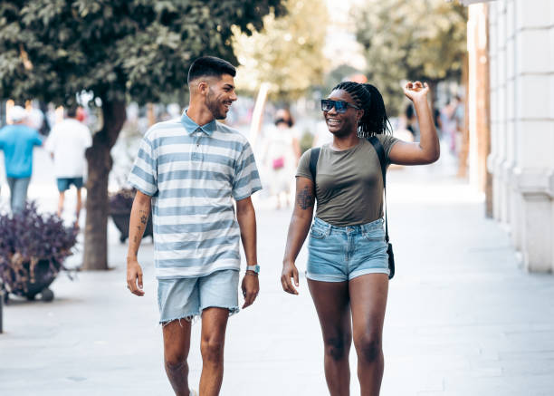 istock Woman gesticulating happily while talking to a man walking in a city 1339237269