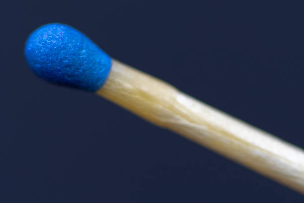 istock match stick with blue head in day on black background. 1339239482