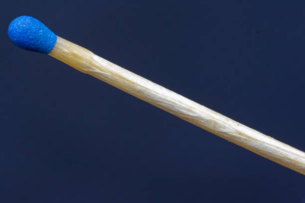 istock match stick with blue head in day on black background. 1339239488
