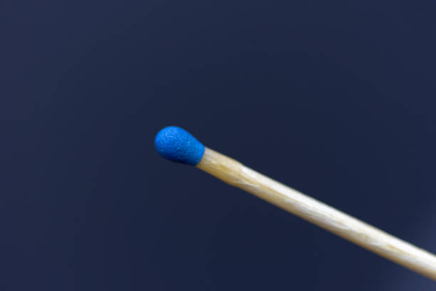 istock match stick with blue head in day on black background. 1339239511