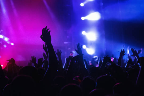 istock Sea of hands under the yellow stage light 1339245304