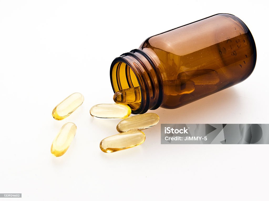 Omega-3 pills from the glass Capsule - Medicine Stock Photo