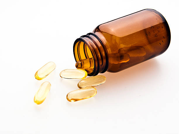 Omega-3 pills from the glass stock photo