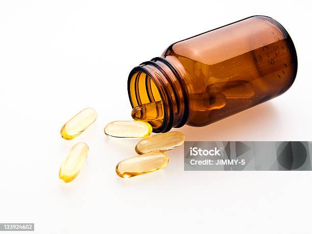 Omega3 Pills From The Glass Stock Photo - Download Image Now - Capsule - Medicine, Glass - Material, Motion