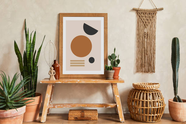 istock Creative composition of stylish living room interior with mock up poster frame, cacti and personal boho accessories. Plant love and nature concept. Template. 1339246669