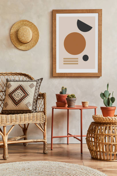 istock Creative composition of stylish living room interior with mock up poster frame, cacti and personal boho accessories. Plant love and nature concept. Template. 1339246723
