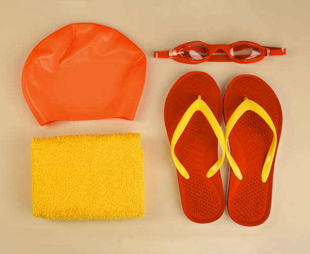 istock Flat lay composition with orange swimming accessories on beige background 1339248012