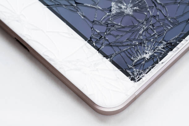istock Broken display screen. Damaged smartphone glass. Closeup, light background, selective focus 1339248216