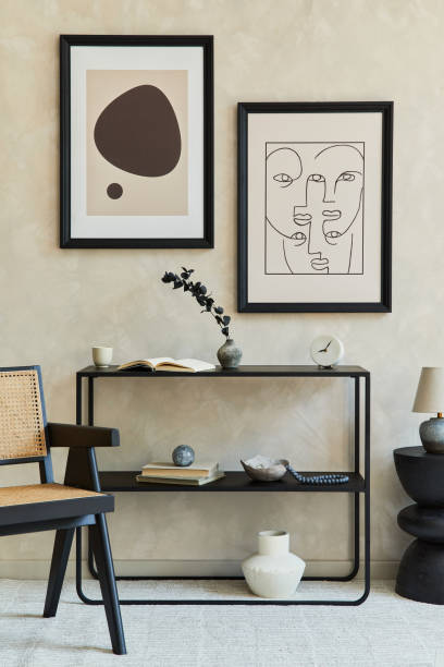 istock Creative composition of stylish modern living room interior with two mock up poster frames, black geometric commode, armchair, lamp and personal accessories. Neutral colours. Template. 1339248487