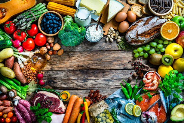 istock Healthy food frame on rustic wood table. Copy space 1339249144