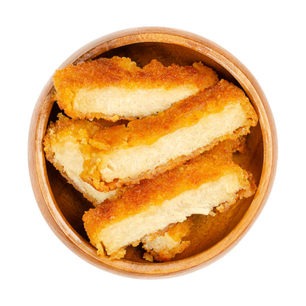Deep-fried vegan schnitzel slices, fried breaded cutlets, in wooden bowl