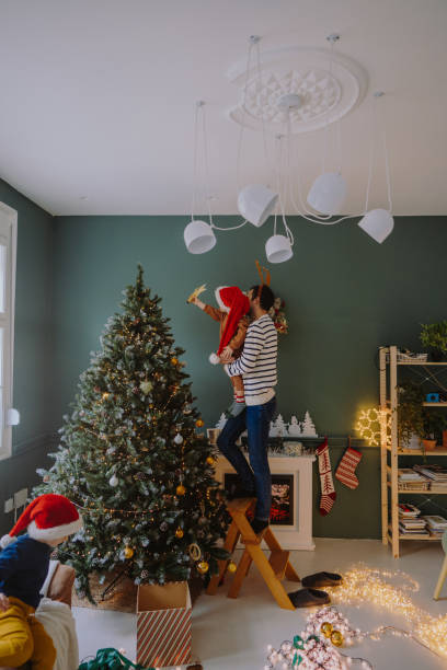 istock Single father's decorating Christmas tree with his boys 1339254554