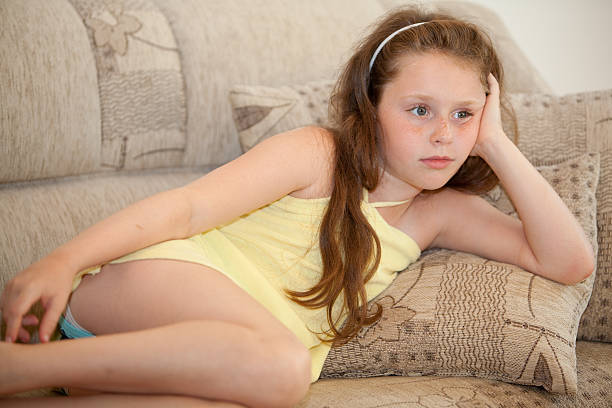 girl rest on sofa and watching TV